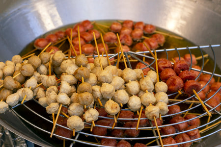 grilled meatballs on skewers in the market, closeup of photoの写真素材