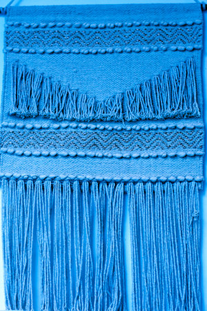 Blue wool scarf close up. Textured background. Blue wool scarf