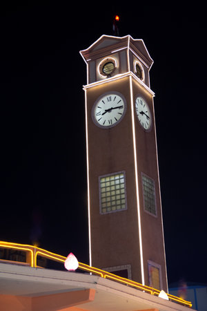 <p>Clock tower in the city at night, closeup photo with selective focus</p>