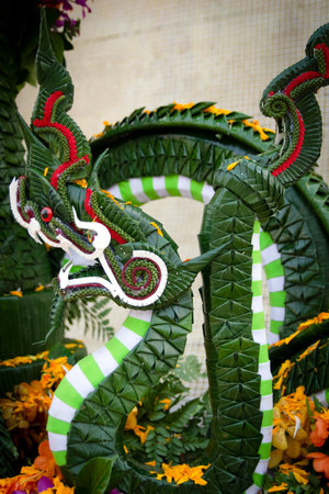 Thai style dragon statue on display at a temple in Thailand.の写真素材