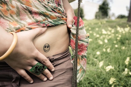 Portrait of a happy face tattoo of a young woman の写真素材