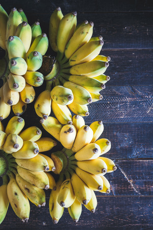 Yellow Bananas on the dark woodの写真素材
