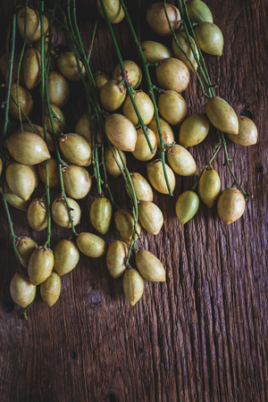 Baccaurea ramiflora fruits on the old woodの写真素材