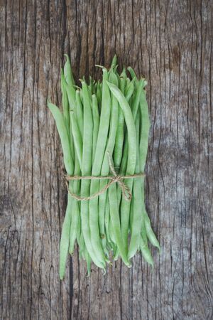 Fresh French beans-Green beans on the old wood background