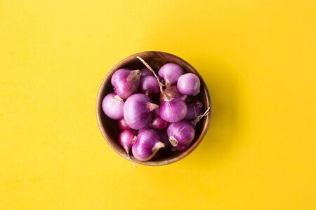 Fresh shallots on the yellow background