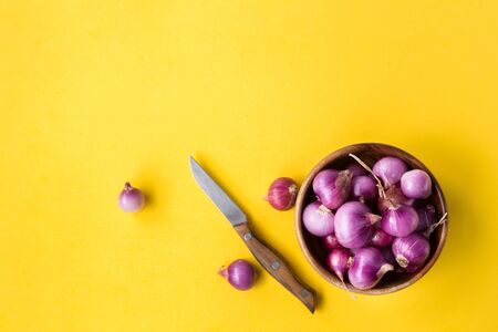 Fresh shallots on the yellow background