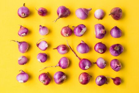Fresh shallots on the yellow background