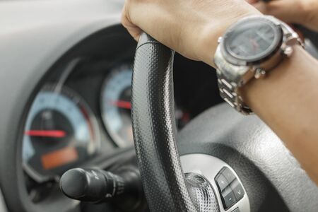 People are driving, close-up hands.