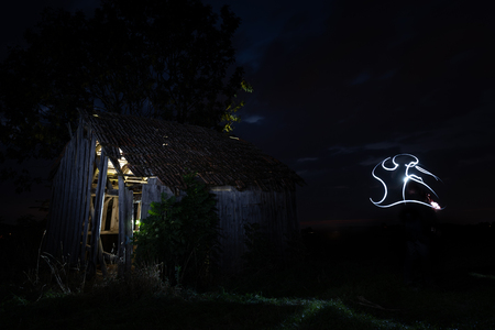 Spooky old derelict house with ghostの写真素材