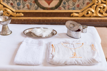 chrisam oil in a vessel and holy water in a bowl. Preparation for the sacrament baptismの写真素材