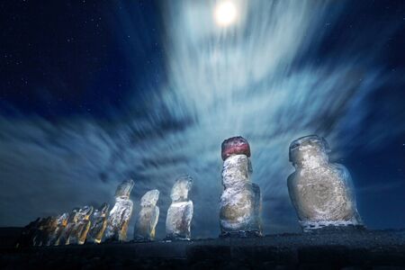 Easter Island statues at night with moonlight and stars in the backgorundの写真素材