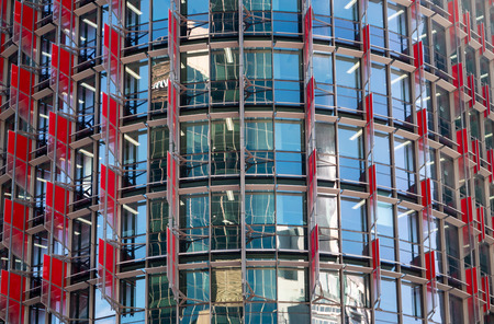 Closeup of blue windows and red walls of a business buildingの写真素材