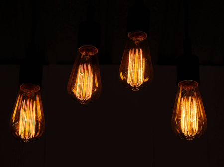 Light orange glow of four lamp,black background.の写真素材