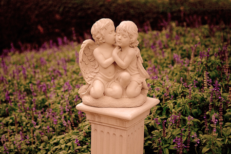 Couple cupid statue kissing in the lavender garden.
