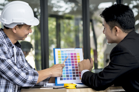 Businessman and engineer have meeting at cafe.の写真素材