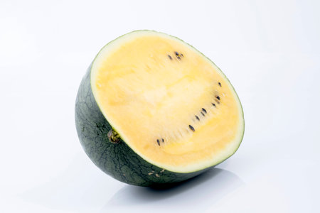 A half of fresh yellow watermelon on white background.の写真素材