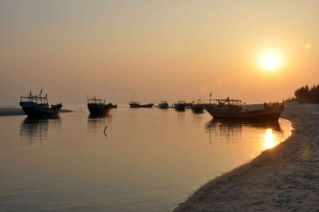 The fishing boats are waiting in sunset.の写真素材