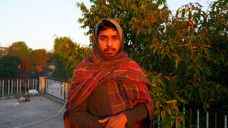January 2020- Mahroli, Jaipur, India. Serious Confident young Indian guy close up, covering his body by woolen sheet in winter season.のeditorial素材