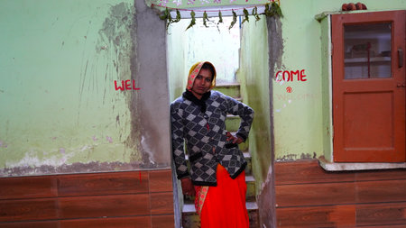 01 January 2020- Reengus, Jaipur, India. Traditional Young Indian woman standing at the enter gate with the supporting of wall. Stylish woman holding hand on back.のeditorial素材
