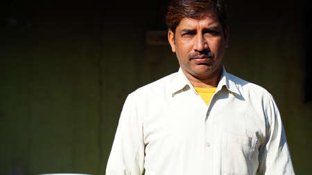 Good looking mature Asian Indian male with white color shirt and black attractive moustache...