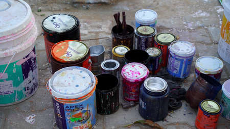 24 February 2021-Khatoo, Jaipur, India. Different color can with color drops. Many used Iron color...