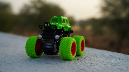 Green monster Truck toy with attractive blurred background. Plastic Dump truck closeup with blurred background.の写真素材
