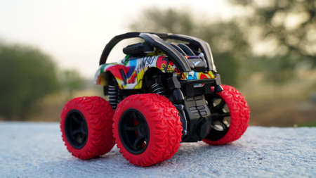 Red black RC Truck closeup with blurred background. Monster big toy with attractive stylish design and spring suspension shocker.の写真素材