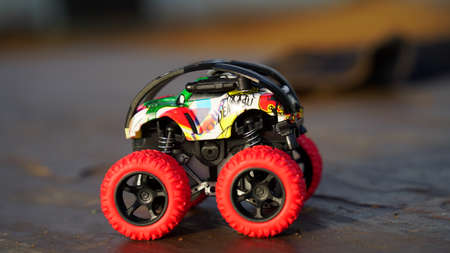 Racing car on the floor. Car toy with big wheels and to play in childhood. Beautiful car toys closeup.の写真素材