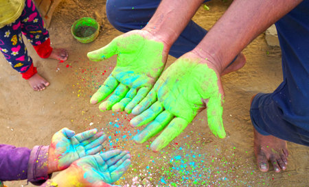Holi festival. Hand with green rangoli colors. Holi and Dhulandi festival concept in India.の写真素材