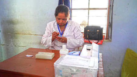 08 April 2021- Akhepura, Sikar, India. Nurse holding syringe before make Covid-19 or coronavirus vaccine. Covid 19 pandemic effect in India.のeditorial素材