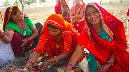 15 April 2021- Reengus, Sikar, India. Religious woman holding a sacred plate and offering prayer in...