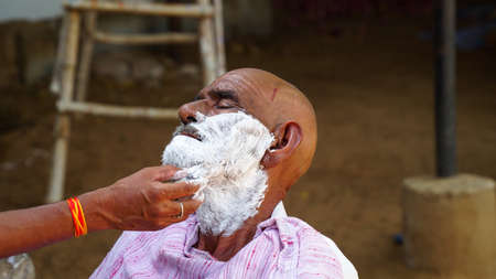 01 January 2021- Reengus, Sikar, India. Indian rural landscape, Local barber go to every day door to door to shave villagers.の写真素材