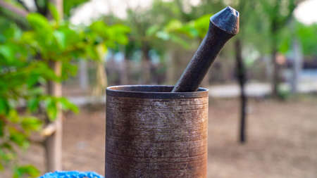 Selective focus on Pestle and Mortar, The pestle is forged by hand and the mortar cast iron. Vintage collection.の写真素材