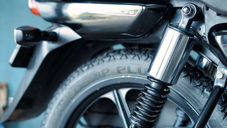 05 October 2021 Reengus, Rajasthan, India. Selective focus on a TVS motorcycle Radeon rear Fork with blurred background.のeditorial素材