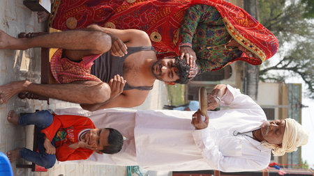 21 November 2021 Reengus, Rajasthan, India. Young Asian groom with his parents celebrate his wedding rituals.のeditorial素材