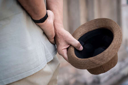 Person holding a beige hat behind the body. Salvador, Bahia, Brazil.の写真素材