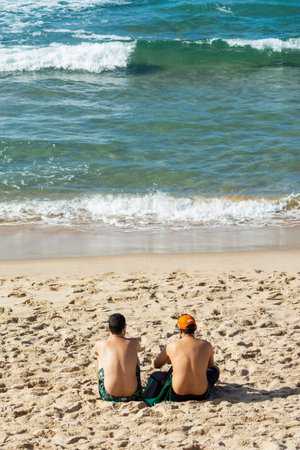 Salvador, Bahia, Brazil - September 24, 2020: People sunbathe on Barra beach lighthouse to relieve the stress caused by the quarantine of the corornavirus pandemic.のeditorial素材
