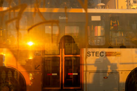 Reflection of the sunset on the glass of the bus stop