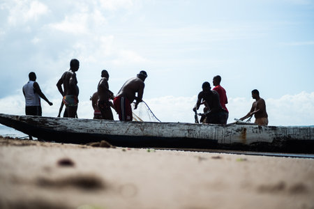 Salvador, Bahia, Brazil - May 23, 2021: Fishermen pulling the fishing net from the sea with fish inside. Boca do Rio beach in Salvador.のeditorial素材