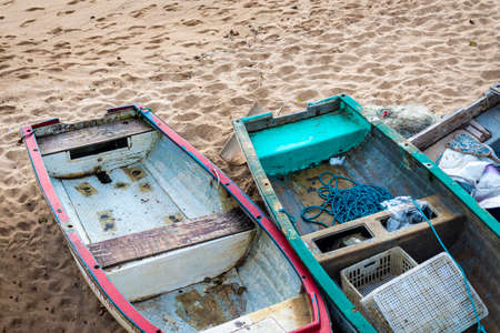 Fishing boats docked in the sand of the Rio Vermelho beach in Salvador. It is wise not to sail overboard on rainy days.の写真素材