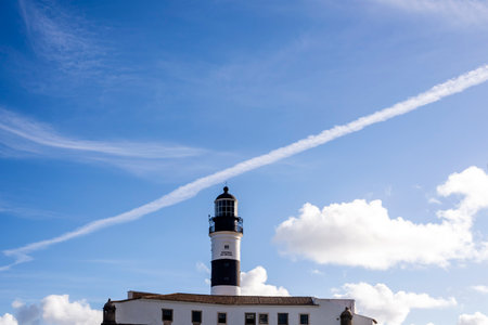 Salvador, Bahia, Brazil - August 08, 2021: Bright blue sky over the famous Farol da Barra. Many visited by tourists from all over the world. A real postcard of the city.のeditorial素材