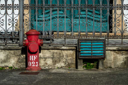 Old red fire hydrant on the streets of Pelourinho. Historic center of Salvador, Bahia, Brazil.の写真素材