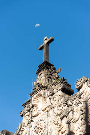 Salvador, Bahia, Brazil - July 18, 2021: Top of a church showing the cross with the moon in the background on a sunny day in the historic center of Pelourinho.のeditorial素材