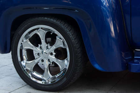 Detail of the wheel of an old car of dark blue color. Salvador Bahia Brazil.の写真素材