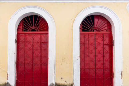 Antique door details in color with shadow, iron, cement, wood.Pelourinho, Salvador, Bahia, Brazil.の写真素材