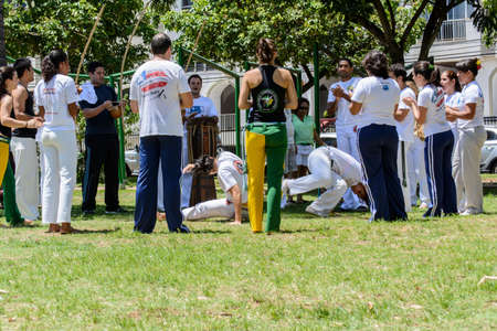 Salvador, Bahia, Brazil - February 23, 2014: Group of capoeristas making art in a square with green grass on a bright sunny day.のeditorial素材