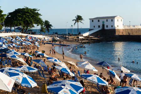 Salvador, Bahia, Brazil - June 17, 2021; People on Porto da Barra beach enjoying the strong sun in the middle of the coronavirus pandemic. Salvador, Bahia, Brazil.のeditorial素材