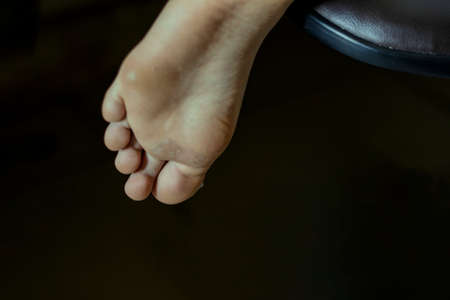 A young man standing resting from a stretch walk. In anatomy, the foot is the extremity of the limbs of land animals that rest on the ground.の写真素材
