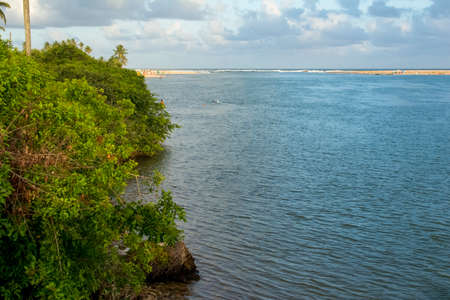 View of the meeting of the sea with the river Jacuipe in Barra do Jacuipe. Camacari, Bahia, Brazil.の写真素材