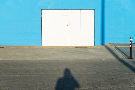 Salvador, Bahia, Brazil - June 17, 2021: Shadow in the street of the photographer himself in the streets of the Barra neighborhood in the late afternoon in Salvador, Bahia.の写真素材